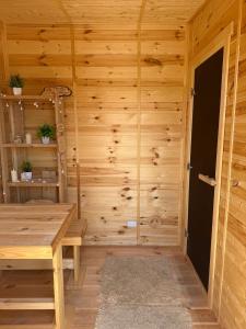 a wooden room with a wooden table and a ladder at 'Белый дом' in Balqash