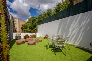 a patio with a table and chairs on grass at Lisbon Poets Inn in Lisbon