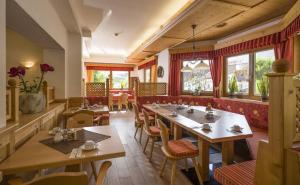 a dining room with tables and chairs in a restaurant at Hotel-Garni Klocker in Kaltenbach