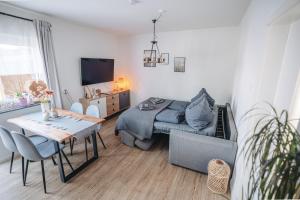 a living room with a couch and a table at Ferienwohnung Leipzig- Hirschfeld Apartments in Leipzig