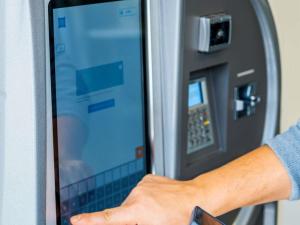 a person is using an atm machine at ibis budget Ulm City in Ulm