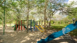 a playground with a slide in a park at Ground floor flat with two suites (up to 8 people) at Canarius Resort in Gravatá in Gravatá