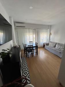 a living room with a table and a couch at Corazón de Nerja in Nerja
