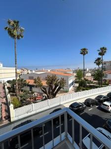 a view from a balcony of a parking lot with palm trees at Corazón de Nerja in Nerja