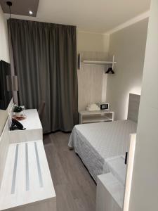 a hotel room with a bed and a desk at Confidence Hotel Suzzara in Suzzara