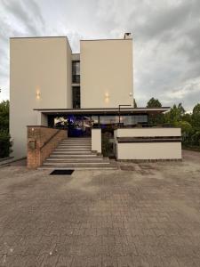 a building with a staircase in front of it at Confidence Hotel Suzzara in Suzzara