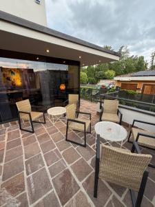 a group of chairs and tables on a patio at Confidence Hotel Suzzara in Suzzara +11 photos