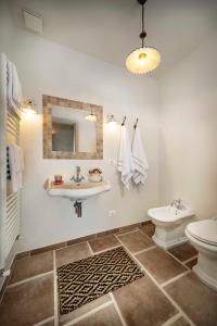a bathroom with a sink and a toilet and a mirror at Casa di Sofia in Calosso +14 photos