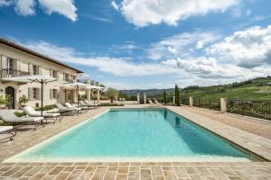 a swimming pool in a villa with patio furniture at Casa di Sofia in Calosso