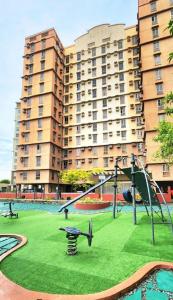 a playground in front of a large apartment building at LUCKY 7 Suites in Manila