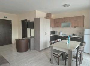 a kitchen and dining room with a table and chairs at Brilliant Aparthotel in Sozopol