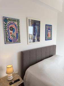 a bedroom with a bed and two pictures on the wall at Art & Motion Union - Sunrise Room in Andros