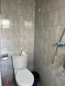 a bathroom with a toilet and a shower at Regeneration in Jinja