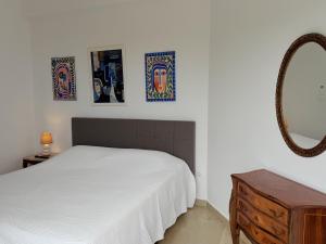 a bedroom with a white bed and a mirror at Art & Motion Union - Sunrise Room in Andros +12 photos