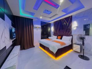 a bedroom with a large bed with lights on it at Don Marble Hotel And Suites in Auchi