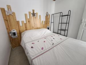 a bedroom with a bed with a wooden head board at la longère du moulin in Noyers-sur-Cher
