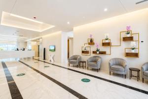 a waiting room at a hospital with chairs and flowers at The Infinity Panorama Batumi in Batumi