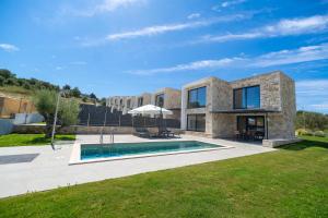 a villa with a swimming pool in a yard at The Olive Path in Kalandra