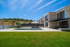 a house with a lawn in front of it at The Olive Path in Kalandra