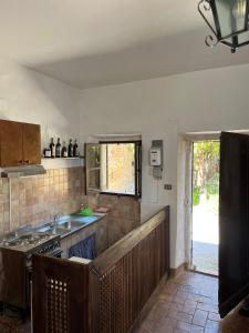 a kitchen with a sink and a stove at Castello di Mongiovino Vecchio "La Casa in Piazza" in Panicale