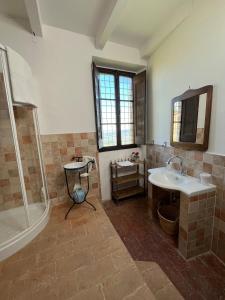 a bathroom with a shower and a sink and a tub at Castello di Mongiovino Vecchio "La Casa in Piazza" in Panicale