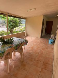 a dining room with a table and chairs and a window at NAEHU TEMAUI A MATUANUI Lodge in Tiputa