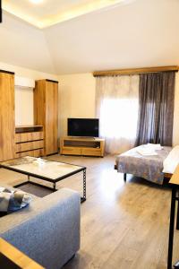 a living room with two beds and a couch at WaterFall Hotel in Yerevan