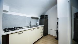 a kitchen with a sink and a stove and a refrigerator at Cupola Blu in Ragusa +15 photos