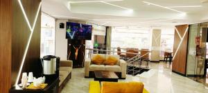 a living room with a couch and a table at BRITNEY HOTEL Machala in Machala +15 photos