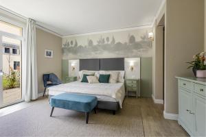 a bedroom with a large bed and a blue stool at Guild Siena Senior Resort & Residence in Siena +56 photos