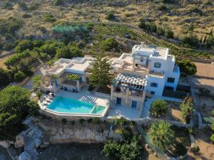 an aerial view of a house with a swimming pool at Paros Tranquility Villa in Dhragoulás