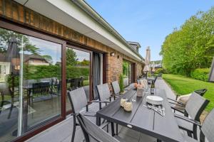 a patio with a table and chairs on a balcony at Ferienwohnung Aquamarin Büsum in Westerdeichstrich