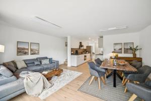 a living room with a couch and a table at Ferienwohnung Aquamarin Büsum in Westerdeichstrich