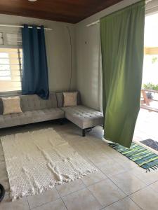 a living room with a couch and a window at NAEHU TEMAUI A MATUANUI Lodge in Tiputa
