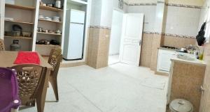 a kitchen with a table and chairs in a room at Maison indépendante pieds dans l'eau in Sousse