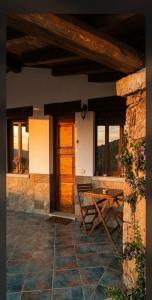 a house with a table and a wooden door at Agriturismo Desole in Monti
