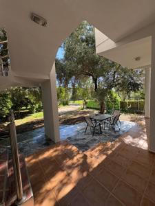 a patio with a table and chairs and a tree at Montebello Inn apartments in Ulcinj