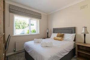 a bedroom with a bed with two towels on it at Almara Guesthouse in Galway +42 photos