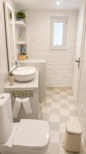 a white bathroom with a sink and a toilet at Est 1852 - Cozy in Andros +8 photos