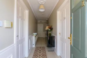a hallway with a door and a television and a rug at Almara Guesthouse in Galway