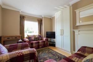 a living room with two couches and a tv at Almara Guesthouse in Galway