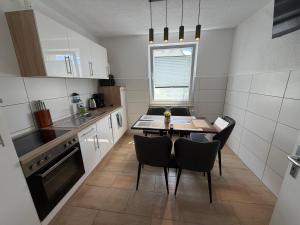 a small kitchen with a table and chairs in it at Ferienwohnung Trinh in Überlingen