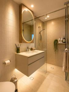 a bathroom with a sink and a shower with a mirror at Koala Sky Suite River & City Views in Brisbane +12 photos