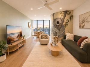 a living room with a couch and a table at Koala Sky Suite River & City Views in Brisbane