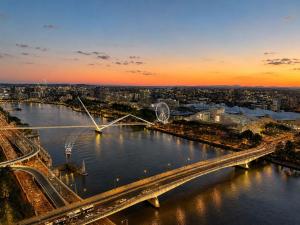 a view of a river with a bridge and a city at Koala Sky Suite River & City Views in Brisbane