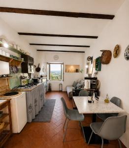 a kitchen and living room with a table and chairs at Casa Amiata 2 in Montelaterone