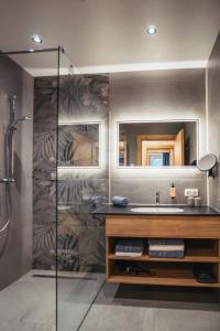 a bathroom with a sink and a shower at Appartementhaus Bergkristall in Kartitsch +33 photos