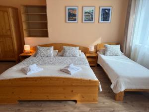 a bedroom with two beds with towels on them at Quota 850 in Tatranská Lomnica