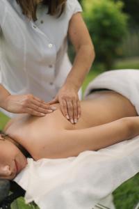 a woman getting a belly massage from a man at Constance Retreat - Douro Verde by FERO in Constance