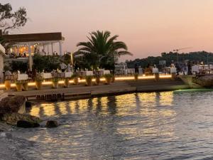 a restaurant next to a body of water at Voula Pool & Sea View & Beach home B1 in Athens